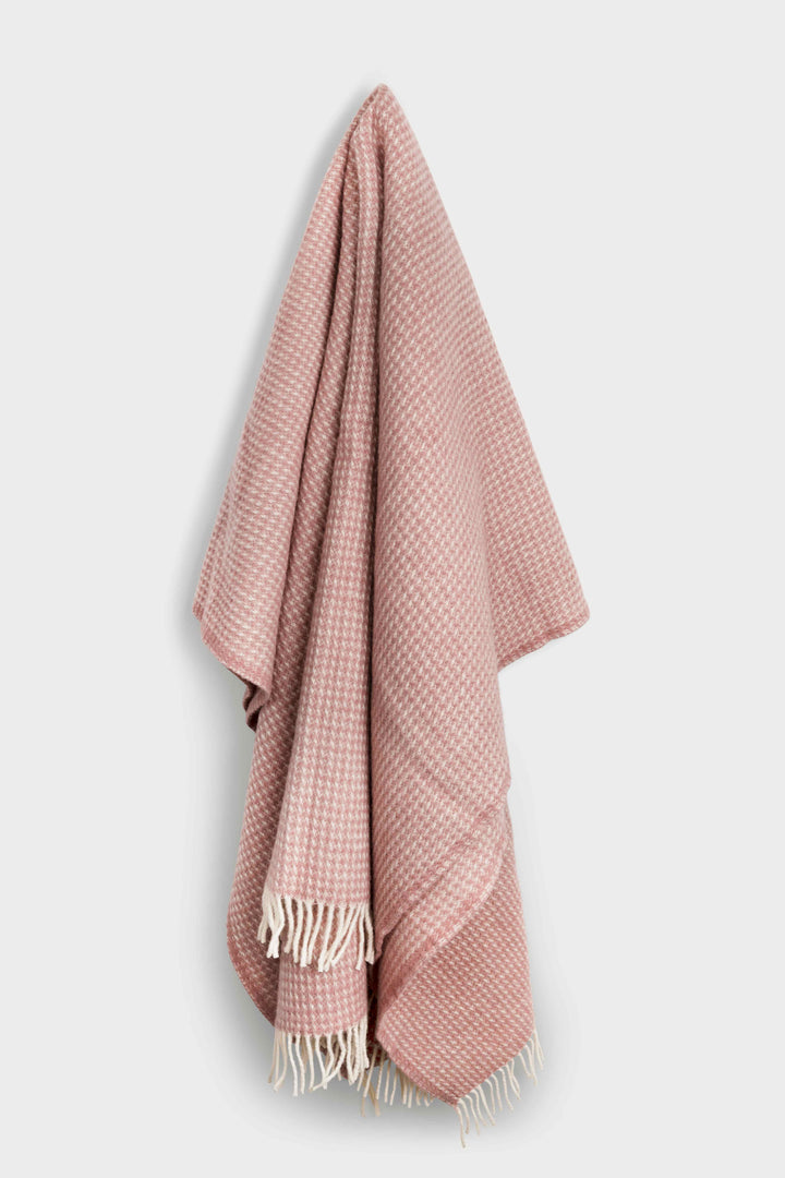 Belle & Aube Grand Waffle blanket in Rosewater hanging on a wall hook, showing natural drape and textured weave