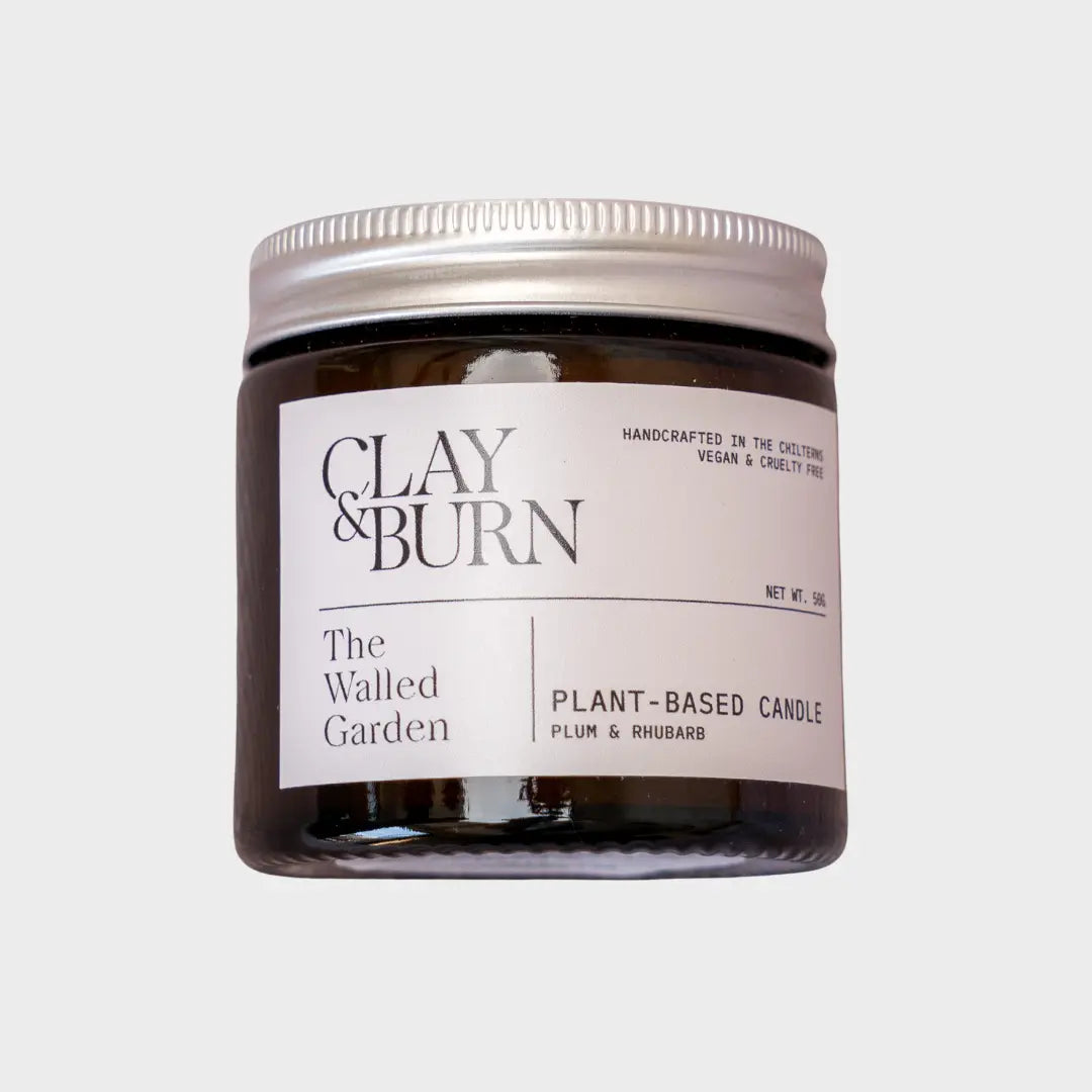 Jar of 'The Walled Garden' plant-based candle by Clay & Burn on a light gray background